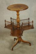 A mid Victorian walnut table with revolving bookcase, with turned central column raised on three