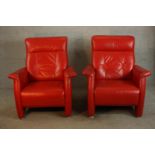 A pair of contemporary red leather armchairs raised on capped metal feet. H.100 W.85 D.90cm. (each)