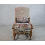 A 19th century carved walnut framed open arm chair, upholstered in Medieval style handmade