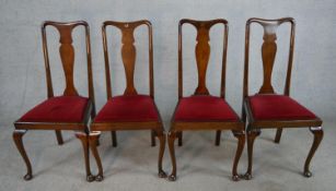 A set of four 19th century Queen Anne mahogany framed dining chairs with shaped splat backs and