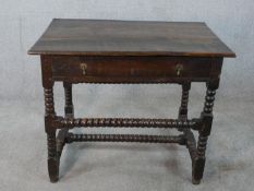 An early 18th century stained oak single drawer sidetable, raised on turned barley twist supports.