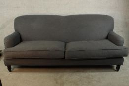 A late 19th century mahogany framed Howard style two settee upholstered with grey fabric, raised