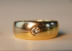 An 18 carat white and yellow gold diamond dress ring. Set to centre with a round old cut diamond