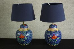 A contemporary pair of Chinese porcelain table lamps, with scroll and floral decoration. H.50 Dia.