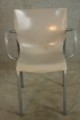 A mid 20th century hard plastic and brushed steel open armchair, raised on straight supports.