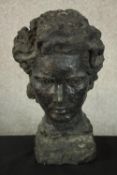 A 20th century black painted plaster bust of a woman. H.33 W.21 D.17cm.