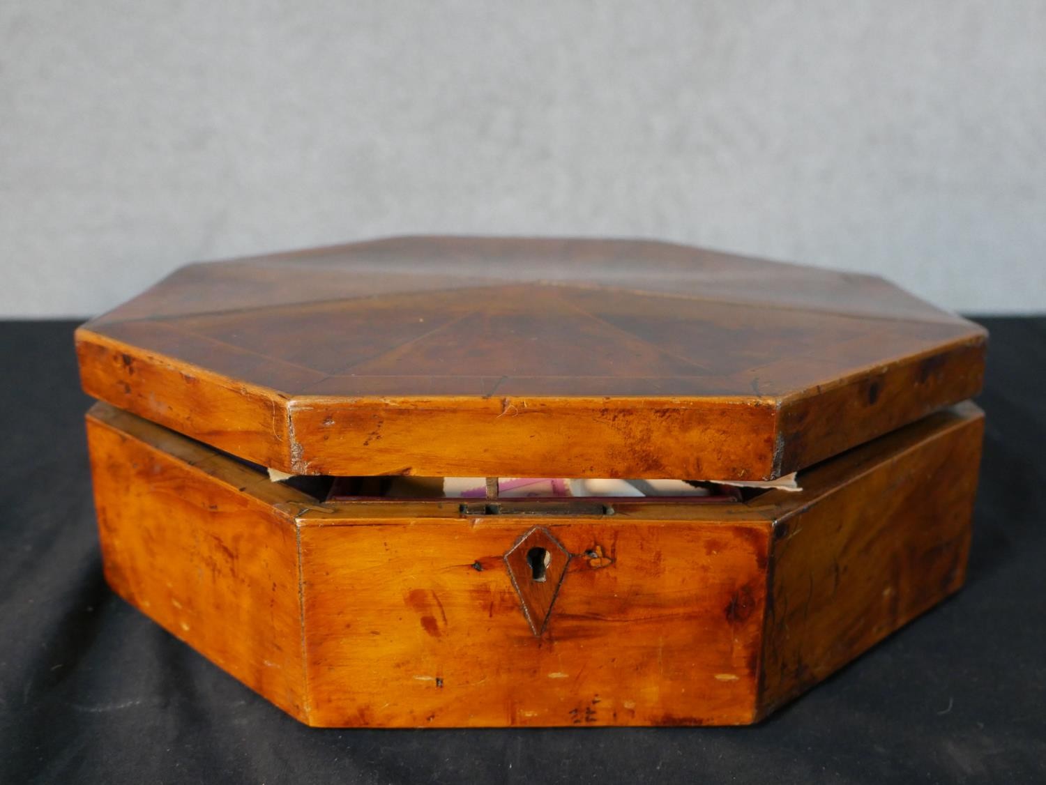 A late 19th century walnut octagonal fabric lined box together with an assortment of loose used