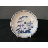 A mid 18th century Chinese café au lait blue and white porcelain saucer dish, decorated with flowers