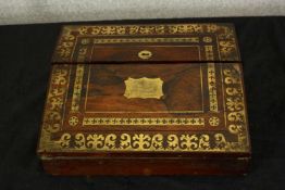 A late 19th century brass inlaid mahogany folding writing box, opening to reveal leather writing