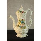 A 20th century Capodimonte pottery floral encrusted jug, the moulded hand in the form of vines and