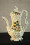 A 20th century Capodimonte pottery floral encrusted jug, the moulded hand in the form of vines and