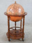 A modern 'terrestrial globe' form drinks cabinet, opening to reveal fitted interior. H.85 Diam.50cm