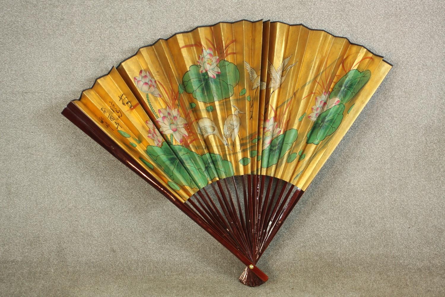 A large 20th century Chinese paper fan decorated with waterlilies. H.89 W.140cm.