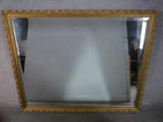 A 20th century rectangular gilt framed bevel edged wall mirror. H.100 W.127cm