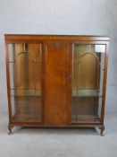 An early 20th century Georgian style twin door mahogany display cabinet; with glass astragal