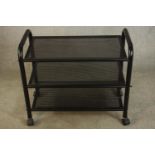 A contemporary three tier black painted metal trolley raised on wheels. H.85 W.75 D.40cm.