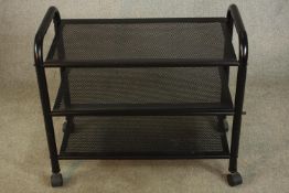 A contemporary three tier black painted metal trolley raised on wheels. H.85 W.75 D.40cm.