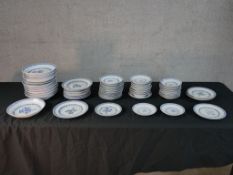 Assorted contemporary Chinese blue and white rice and floral design porcelain plates and saucers.