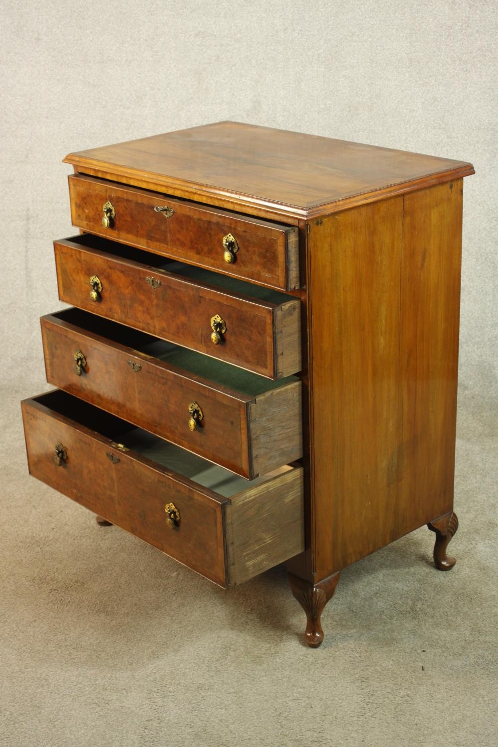 A 20th century walnut veneered chest of four graduating drawers, with brass swing handles, raised on - Image 4 of 9