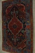 A red ground Persian Zanjan woollen rug, with all over geometric pattern. L.195 W.125cm.