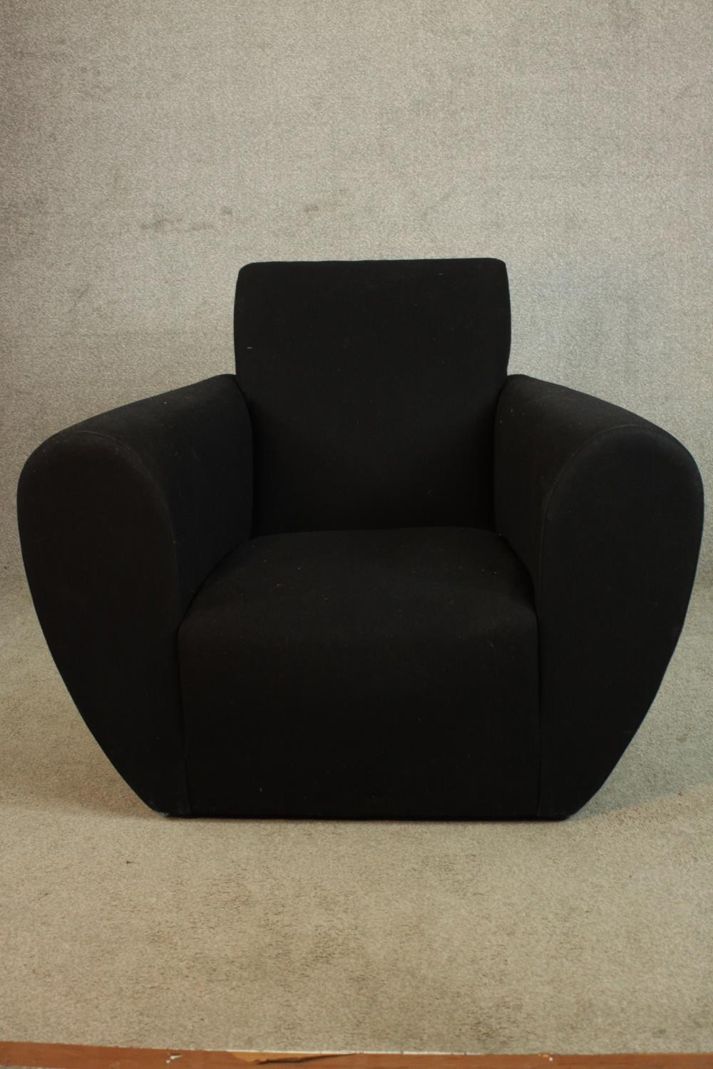 A contemporary low upholstered armchair. H.78 W.82 D.82cm.