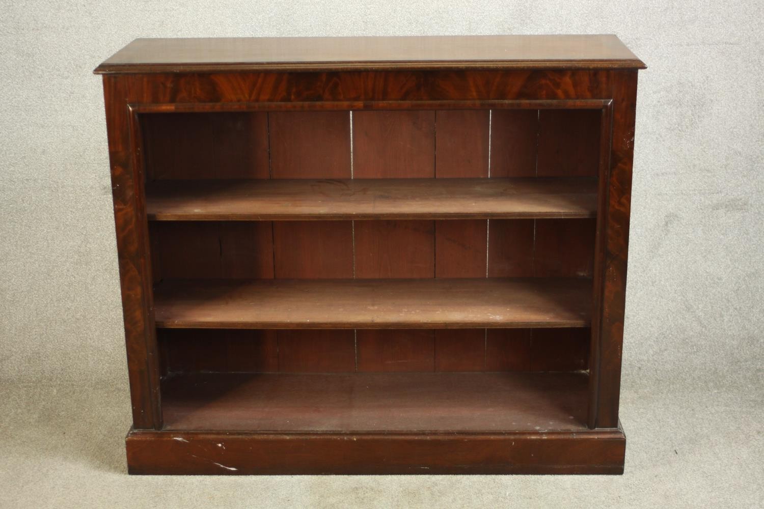 A 20th century mahogany three tier open bookcase, raised on block plinth base. H.102 W.121 D.38cm.
