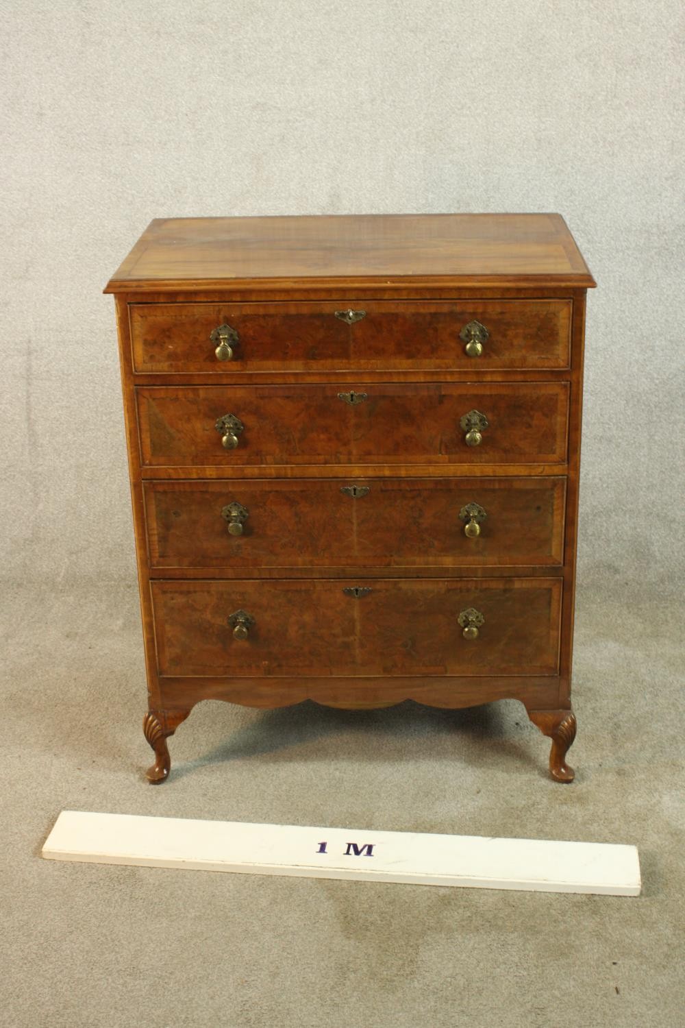 A 20th century walnut veneered chest of four graduating drawers, with brass swing handles, raised on - Image 2 of 9