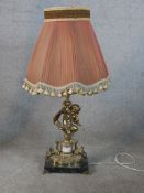 A 20th century cast brass cherub table lamp standing on square marble base, raised on four brass