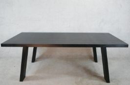 A contemporary black painted Porro table, raised on splayed plank legs, with original label. H.70