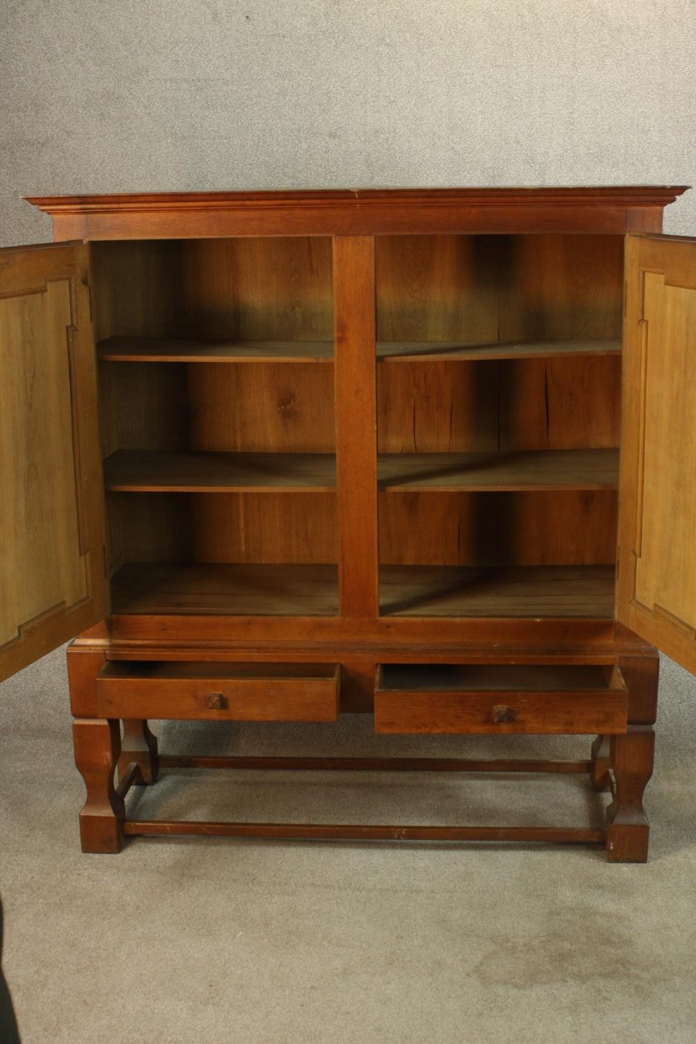 A late 19th century oak two door cupboard with two drawers below, raised on heavily carved - Image 3 of 10