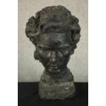 A 20th century black painted plaster bust of a woman. H.33 W.21 D.17cm.