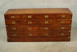 A 20th century mahogany and brass strapped campaign style chest of four short over six longer