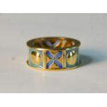 A contemporary 18 carat yellow gold and enamel sectioned XO design band. Stamped 750 and signed