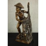 An early 20th century carved Chinese hardwood fisherman, raised on naturalistic base. H.63 W.25 D.