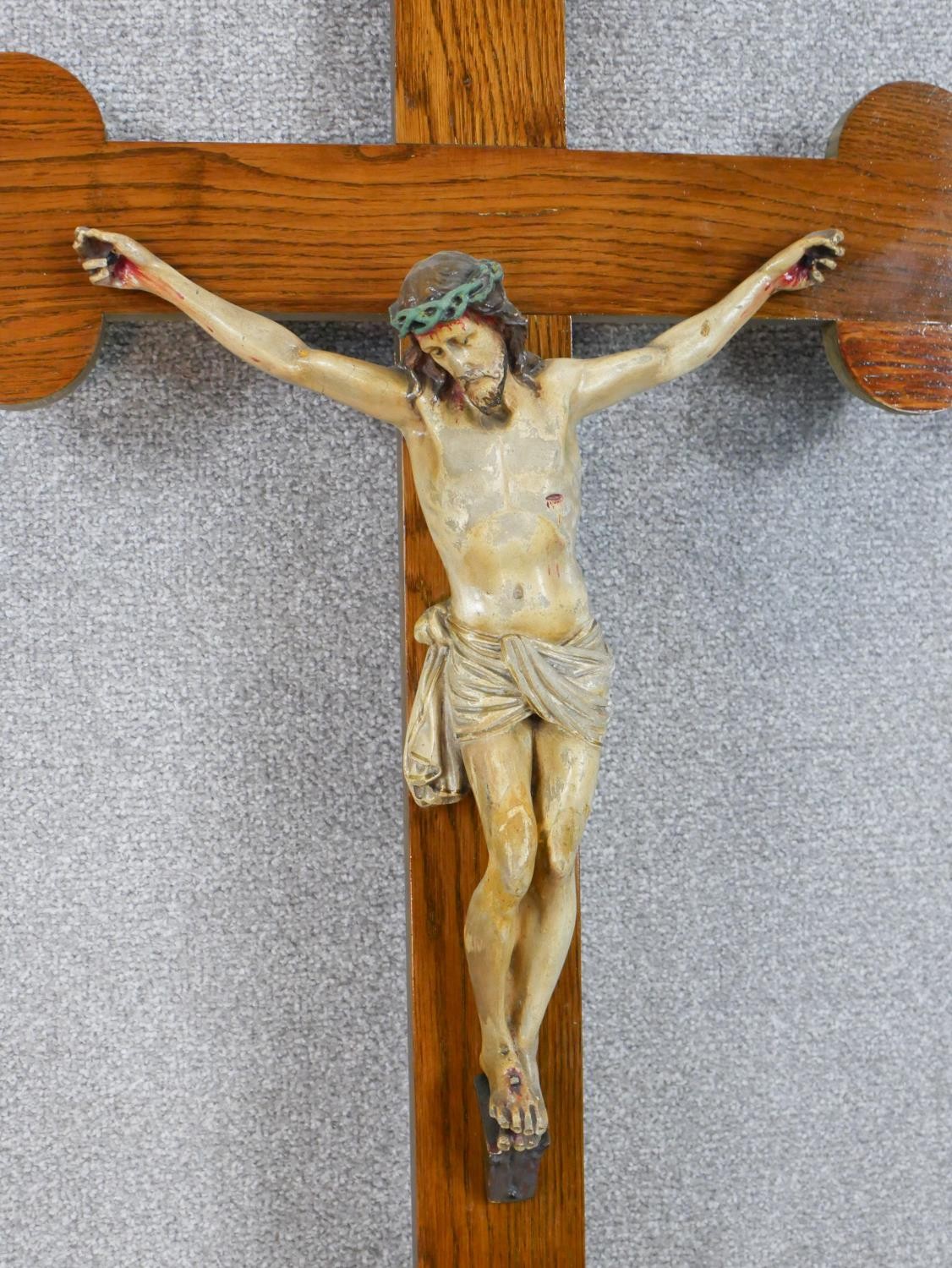 A late 19th/early 20th century oak form crucifix, mounted with a painted carved figure of Jesus - Image 2 of 4