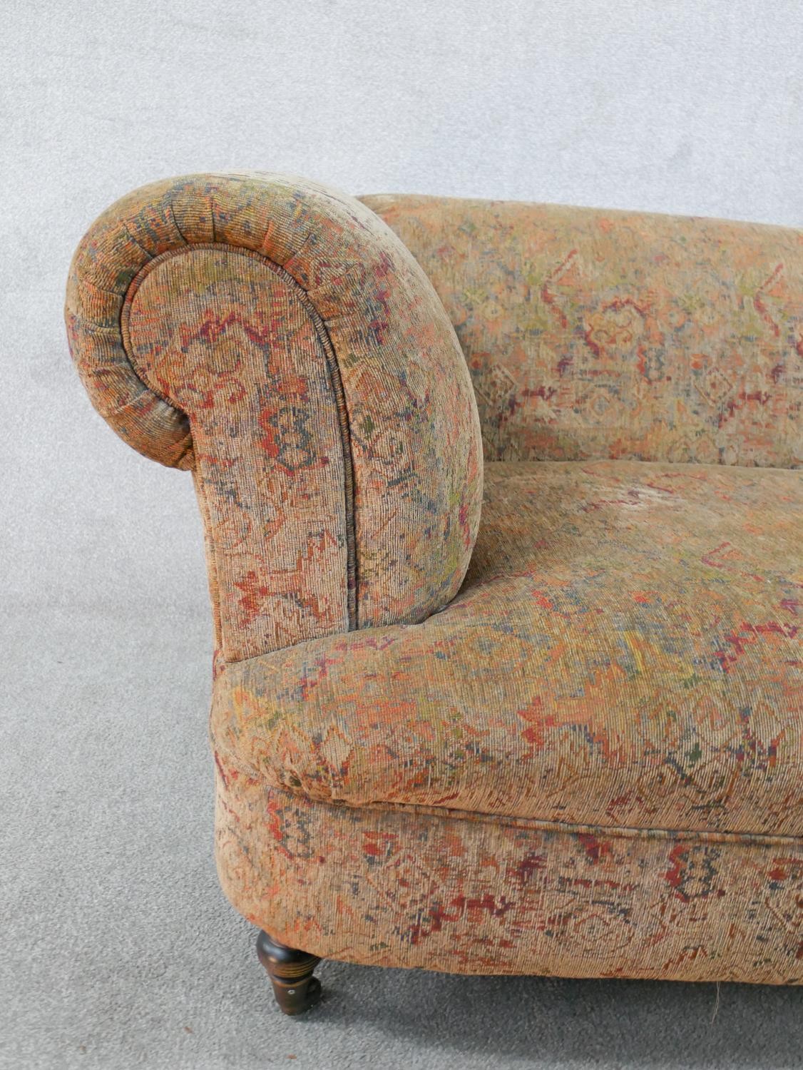 A 19th century upholstered two seater scroll arm settee, raised on turned supports. H.66 W.170 D. - Image 3 of 4