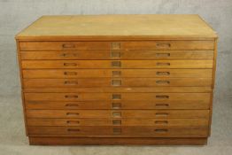 An early 20th century beech ten drawer plan chest, each with incised handles. H.92 W.148 D.90cm.