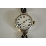 An Art Deco silver watch with white enamel dial with Roman numerals and stop watch dial. Hallmarked: