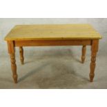 A 20th century pine rectangular farmhouse kitchen table, raised on turned supports. H.77 W.136 D.