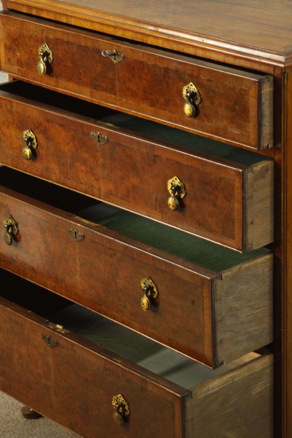 A 20th century walnut veneered chest of four graduating drawers, with brass swing handles, raised on - Image 6 of 9
