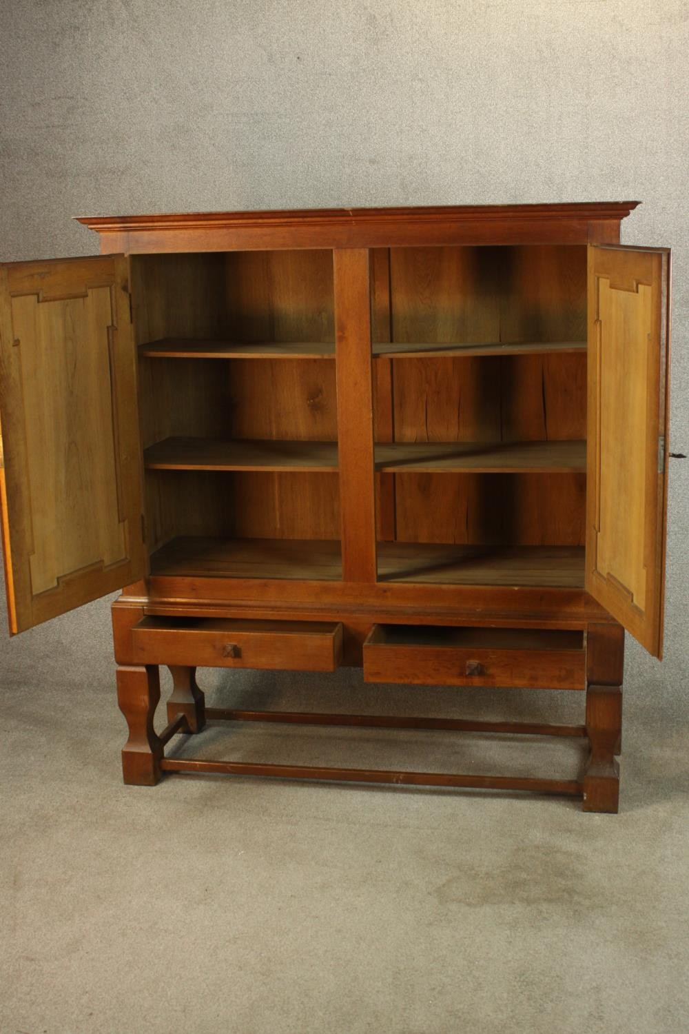 A late 19th century oak two door cupboard with two drawers below, raised on heavily carved - Image 4 of 10