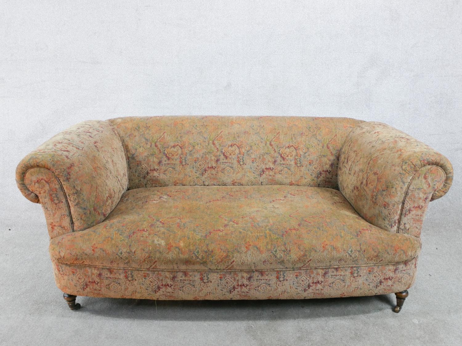 A 19th century upholstered two seater scroll arm settee, raised on turned supports. H.66 W.170 D.