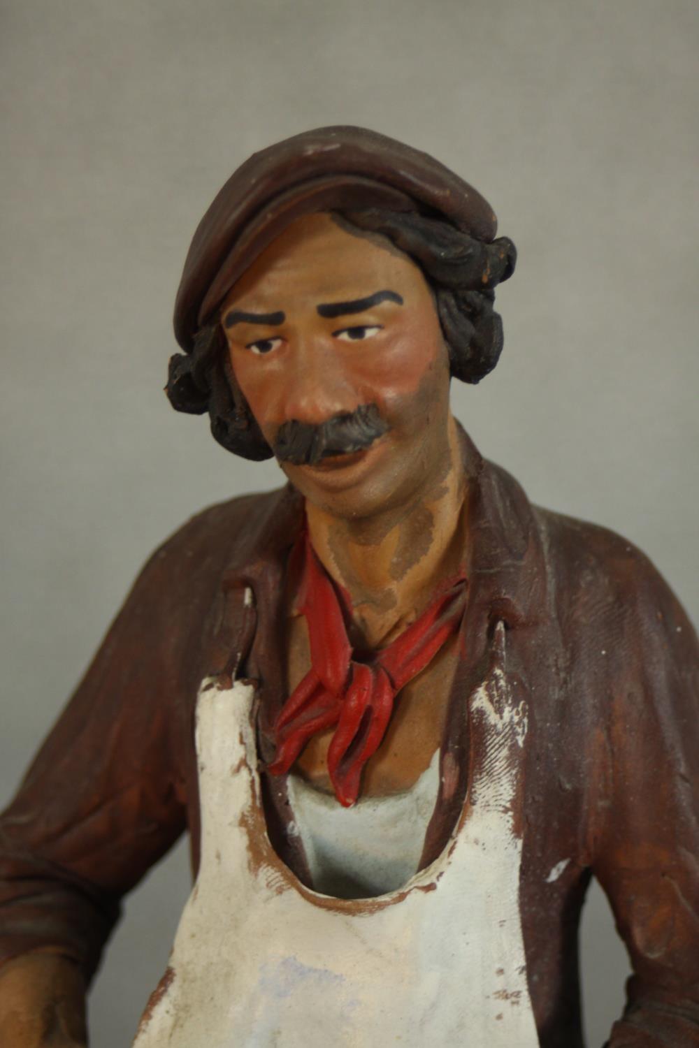 A 20th century Russian painted pottery figure of a a fishmonger, impressed marks. H.25 W.13 D.11cm. - Image 3 of 6