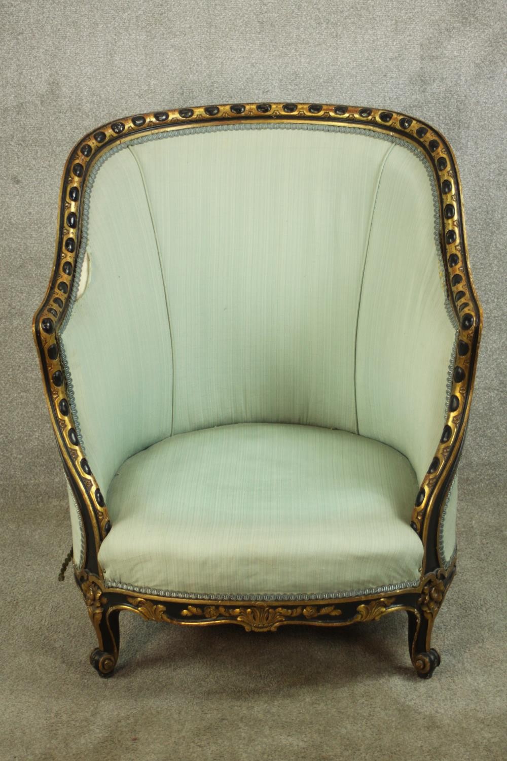 A French Louis XV style tub chair, with egg and dart frame, upholstered in sky blue fabric, raised