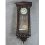 A late 19th / early 20th century oak cased regulator style wall clock, the white dial with black