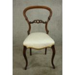 A Victorian mahogany balloon and pierced bar back single bedroom chair, with stuff over seat