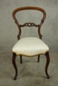 A Victorian mahogany balloon and pierced bar back single bedroom chair, with stuff over seat