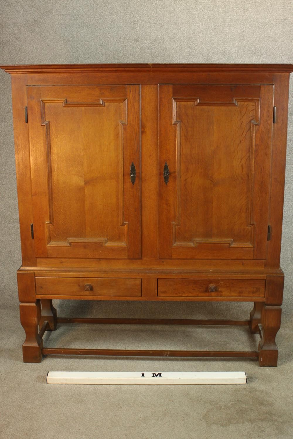 A late 19th century oak two door cupboard with two drawers below, raised on heavily carved - Image 2 of 10