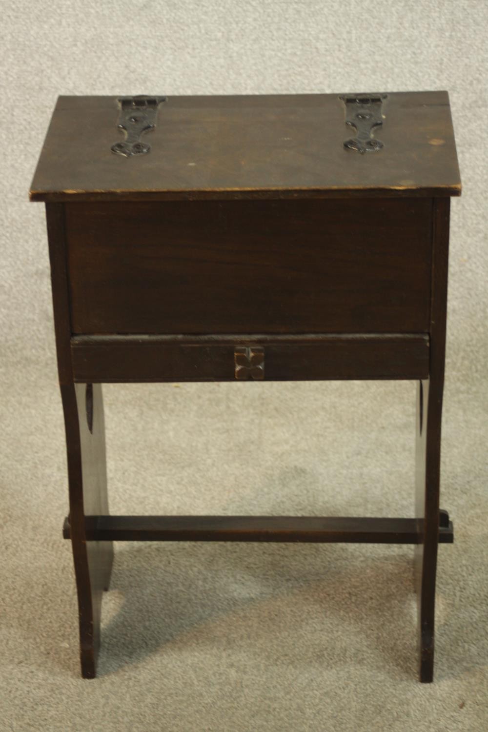 A 19th century stained oak floor standing sewing box, raised on pierced heart shaped trestle