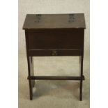 A 19th century stained oak floor standing sewing box, raised on pierced heart shaped trestle